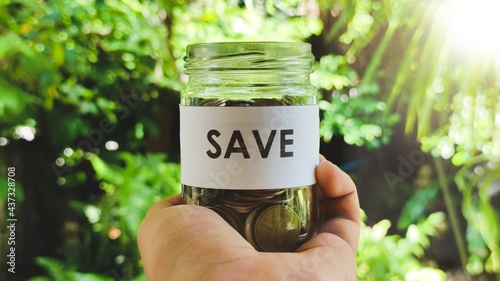 Saving money and account concept, money coin in glass jar growing business. 