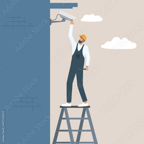 Professional workers installing cctv security camera on the building wall Safety and surveillance concept