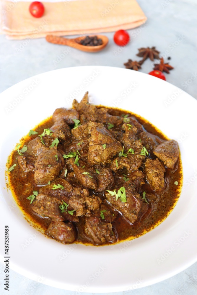 Chicken Liver Masala or Kaleji fry garnished with coriander. Liver fry is a very popular Nonvegetarian Indian dish. Made from Chicken liver. White background. copy space with spices. Chicken Liver Masala or Kaleji fry garnished with coriander. Liver fry is a very popular Nonvegetarian Indian dish. Made from Chicken liver. White background. copy space with spices.