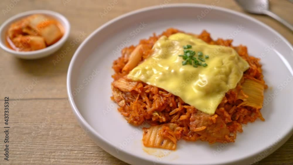 kimchi fried rice with pork and topped cheese - Asian and fusion food style kimchi fried rice with pork and topped cheese - Asian and fusion food style