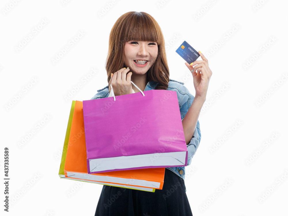 Woman holds credit card and shopping bags. Woman holds credit card and shopping bags.