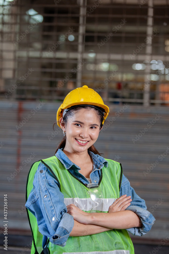 Portrait of woman Asian factory worker standing with arms crossed in factory Portrait of woman Asian factory worker standing with arms crossed in factory