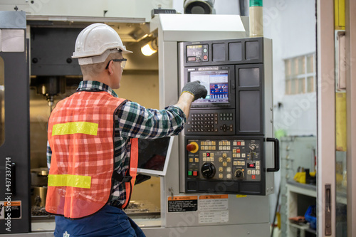 Engineer control and check robot working in factory. The worker is controlling the robot to work in the factory. Portrait of female factory worker. Engineer women are working with machines cnc