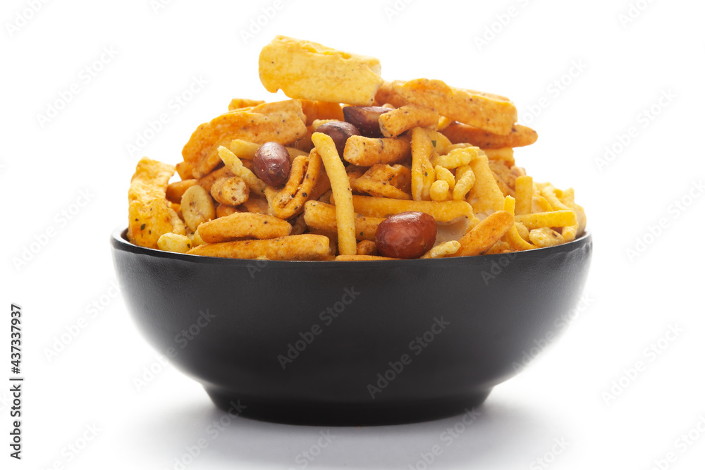 Close-Up of Indian spicy snacks (Namkeen) - (All in one) in a black Ceramic bowl, made with fried peanut, corn flakes, sweet pea, pulses, cashew nuts. Close-Up of Indian spicy snacks (Namkeen) - (All in one) in a black Ceramic bowl, made with fried peanut, corn flakes, sweet pea, pulses, cashew nuts.