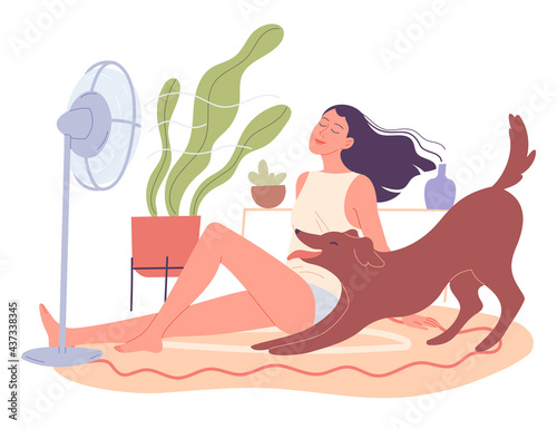 Girl and her dog are chilling at home by the fan