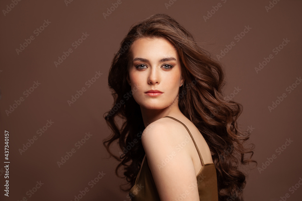 Beautiful hair long curly hairstyle woman with beauty makeup female model studio portrait Beautiful hair long curly hairstyle woman with beauty makeup female model studio portrait