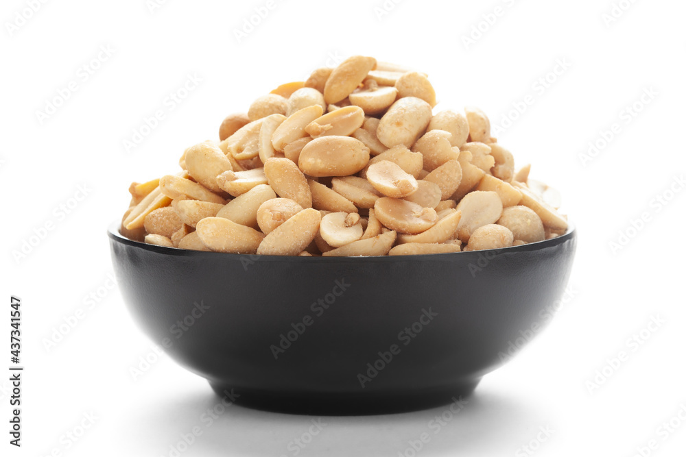 Close up of crunchy roasted Peanuts Indian namkeen (snacks) on a ceramic black bowl. Top view Close up of crunchy roasted Peanuts Indian namkeen (snacks) on a ceramic black bowl. Top view