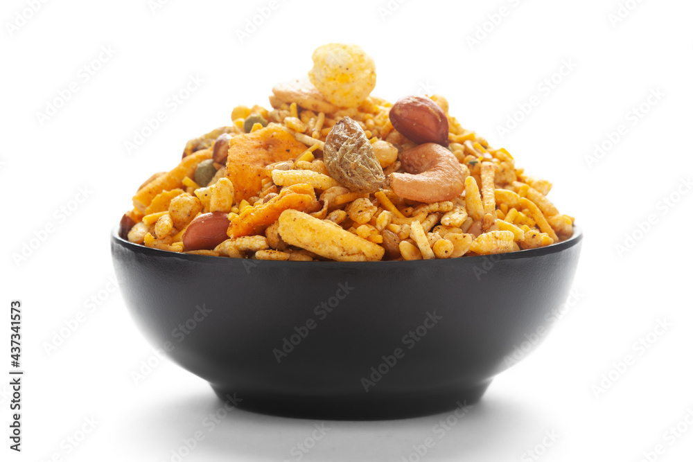 Close up of corn flex mixture Indian namkeen (snacks) on a ceramic black bowl. Close up of corn flex mixture Indian namkeen (snacks) on a ceramic black bowl.
