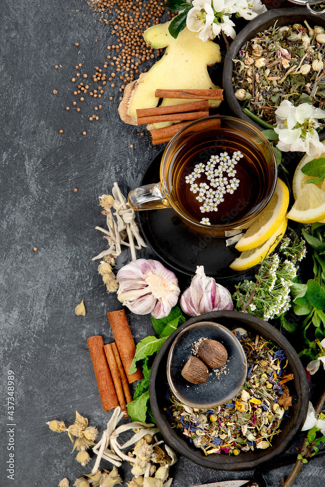 Various kinds of herbal tea on dark background. Natural herbs medicine.