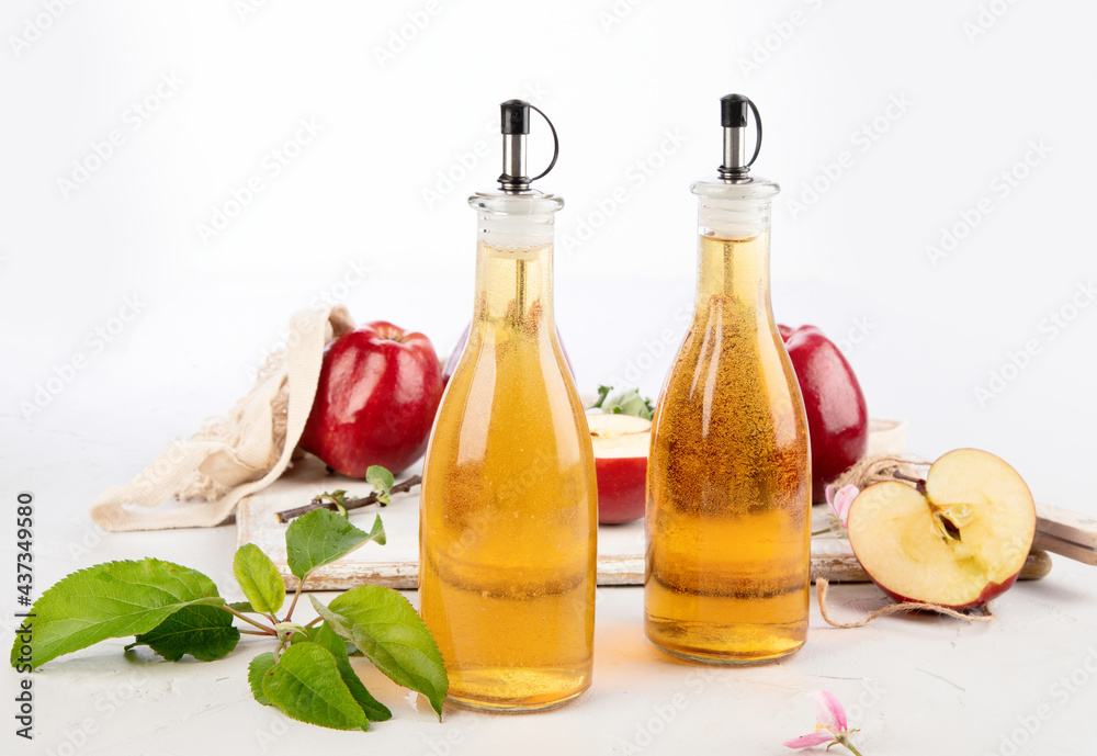 Apple cider vinegar and fresh apples on light background. Healthy organic food. Apple cider vinegar and fresh apples on light background. Healthy organic food.