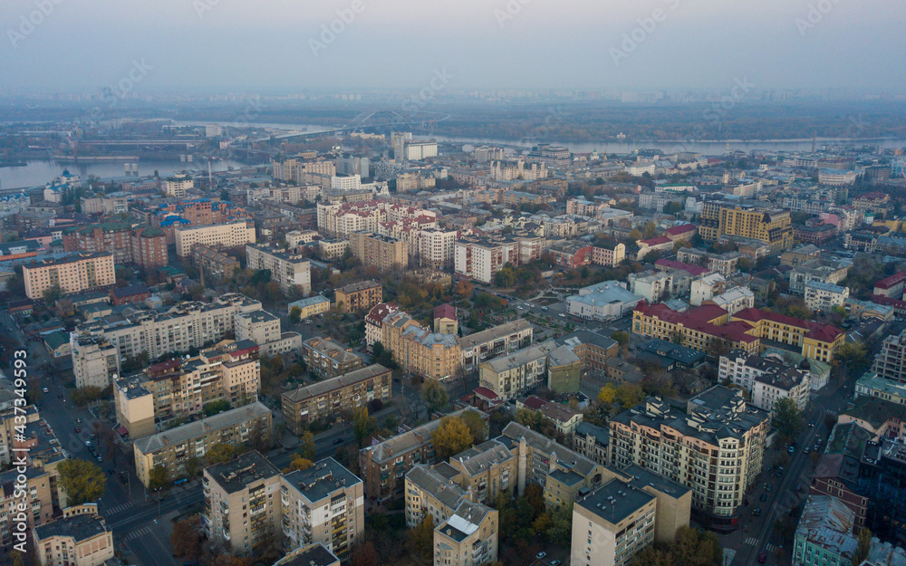Aerial view of Kyiv city in at sunset. Podil historical district skyline from above. Old centre at dusk, Ukraine