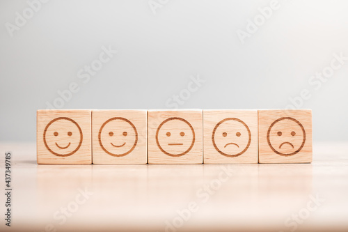 emotion face symbol on wooden blocks. Service rating, ranking, customer review, satisfaction, evaluation and feedback concept