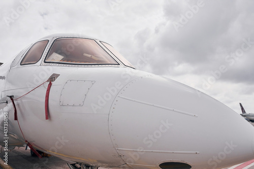 Front view. Turboprop aircraft parked on the runway at daytime