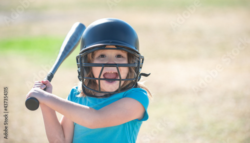 Portrait of excited kid baseball player wearing helmet and hold baseball bat.