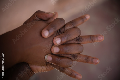 AFRICAN MAN AND WOMAN HOLDING HANDS, 