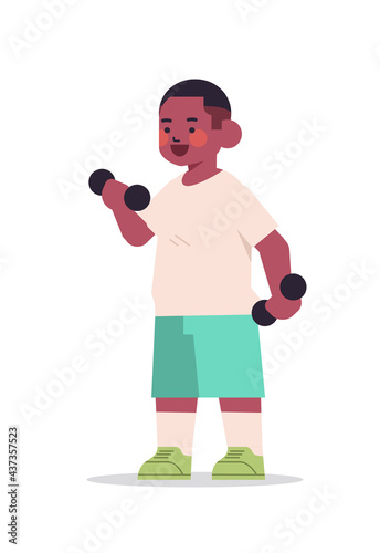 little african american boy doing physical exercises with dumbbells healthy lifestyle childhood concept