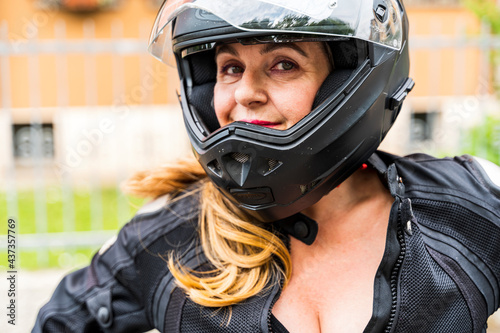 portrait of mature woman with motorcycle helmet outdoors © Marino Bocelli