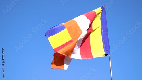Slow motion shot of Colorful Buddhist Tibetan prayer flag against the blue sky at Pangan Nyingma Monastery in Patlikuhal village near Manali, Himachal Pradesh, India