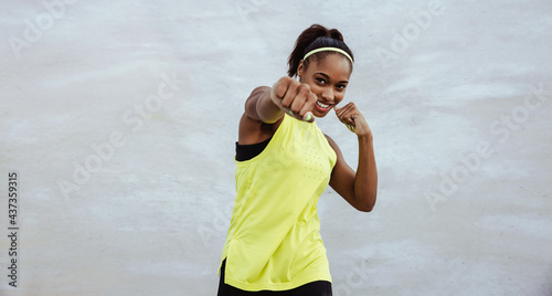 Fitness female doing shadow boxing exercise photo