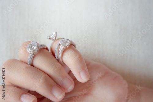 diamond rings on woman finger.love and an elegant wedding white gold ring concept