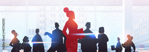 red businesswoman leader silhouette standing in front of businesspeople group leadership business competition