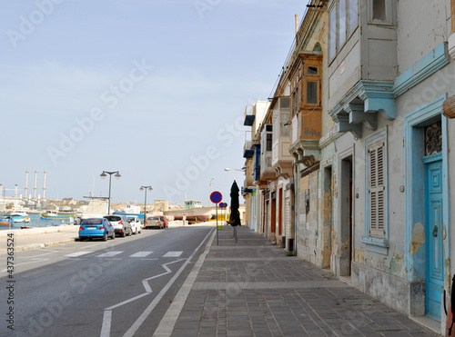 Street in Marsaxlokk with beautiful traditional houses built of light yellow local stone. Malta, Eorope