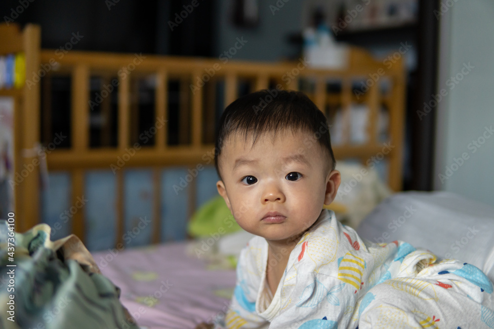 Portrait image of adorable and lovely asian boy just wake up during morning