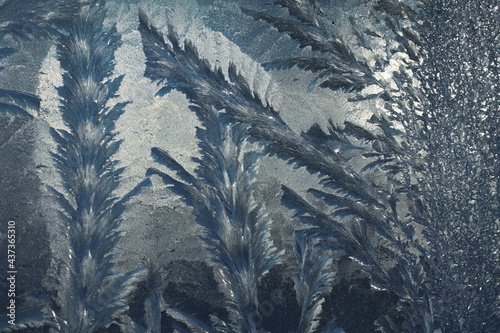 Frost patterns on the window in winter
