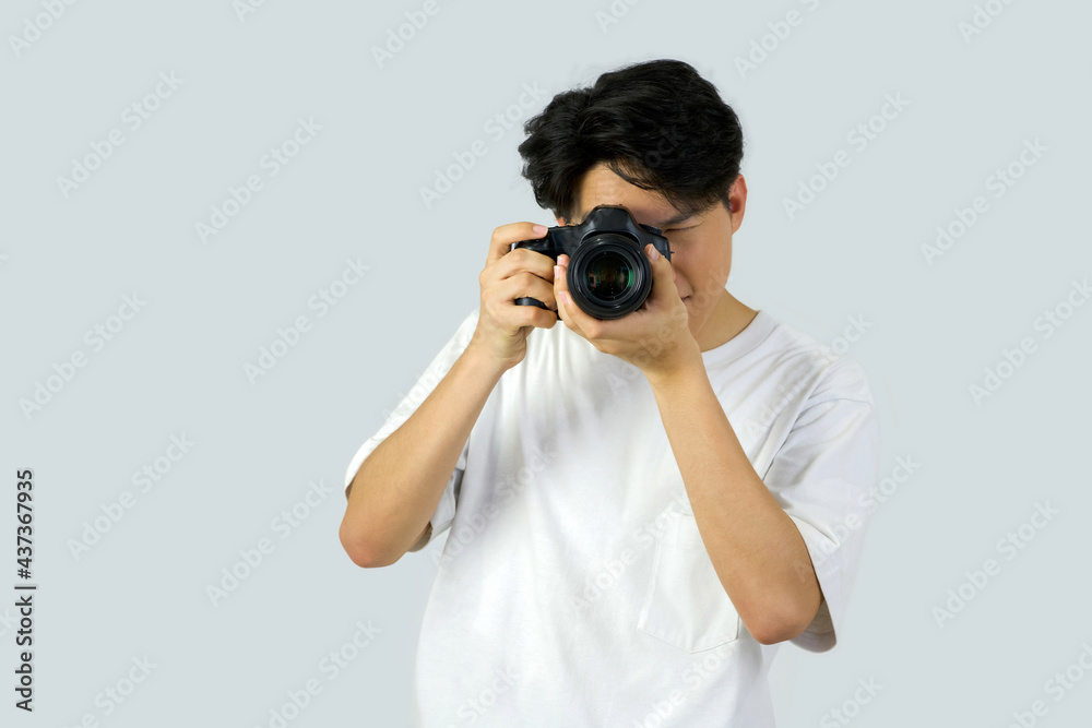 Dslr full frame camera in photographer's hand. Working atmosphere in the photo studio. Dslr full frame camera in photographer's hand. Working atmosphere in the photo studio.