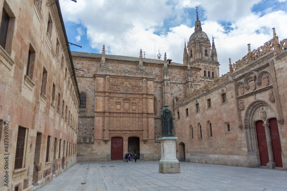 View at the patio de escuelas, central University plaza with Salamanca Museum and University of Salamanca buildings and Fr Luis de Leon statue