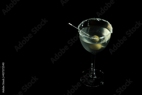 Luxury cocktail glass on black background. High end beverage in bar.