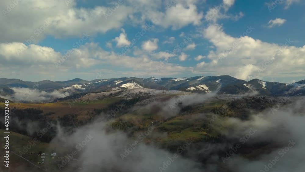 Flying over a mountain landscape in the clouds Flying over a mountain landscape in the clouds