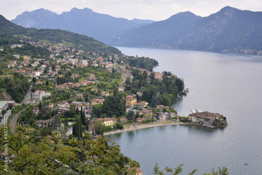 Panorama of Lierna mountain lake Como surrounded by green hills covered with cedar forest