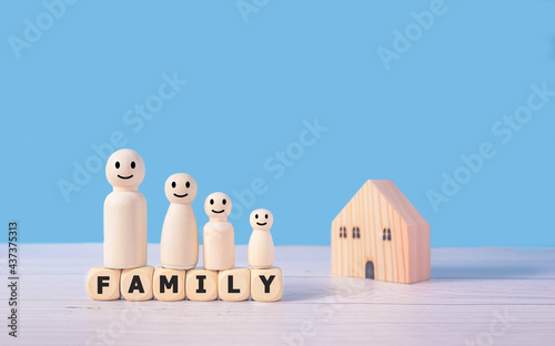 Family words and wooden figures standing on wooden blocks consist of parents and children.Family together protection and safety Property and home insurance and managing real estate investment concept.