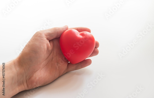hand holding heart on white background. World Health day concept. Heart health and peace concept. World organ donation day. Concept of healthy heart for healthy life. selective focus
