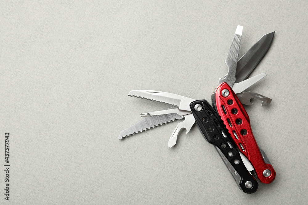 Obraz na plátne Compact portable multitool on light grey background, top view