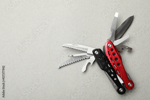 Obraz na plátne Compact portable multitool on light grey background, top view