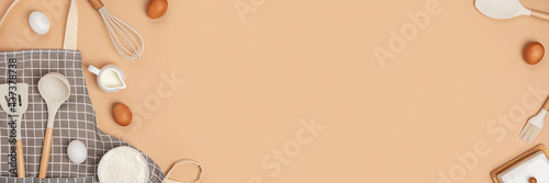 Fotografia Banner made with baking ingredients and cooking utensil with copy space on light brown background