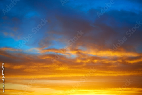 Dramatic sky at sunset with red, yellow, orange and blue clouds