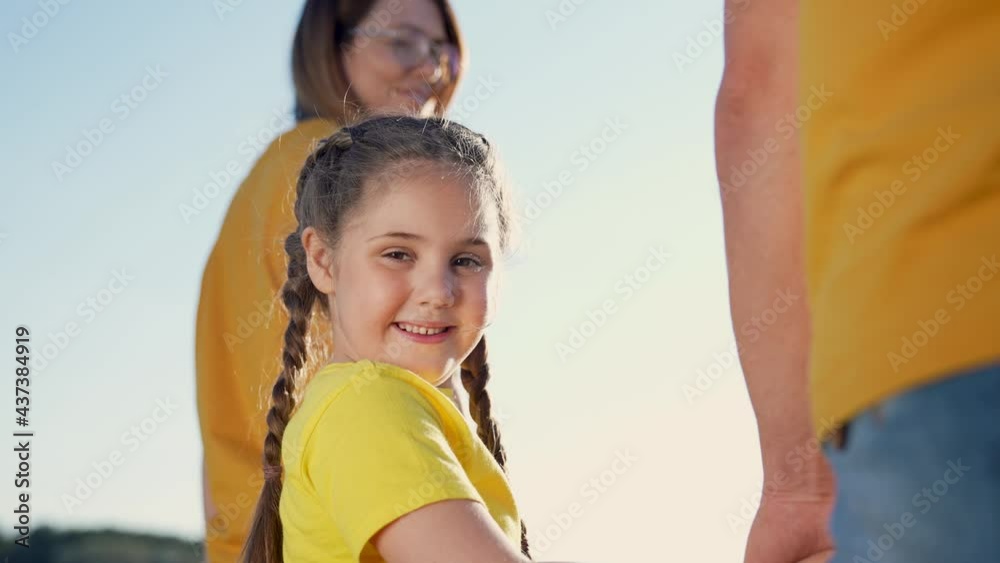 Happy family walks in park in sun at sunset. Mom, dad and baby happy walk at sunset. Joint family walks healthy lifestyle. The concept of happy family and family values. Parents and daughter in park Happy family walks in park in sun at sunset. Mom, dad and baby happy walk at sunset. Joint family walks healthy lifestyle. The concept of happy family and family values. Parents and daughter in park
