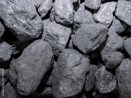 Macro of carbon stones piled up for their subsequent combustion forming an energetic background of this precious mineral used in homes for combustion and producing heat energy to heat the home photo