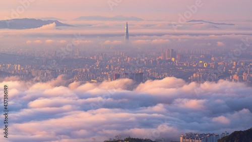 Zoom in, A sea of ​​mist covers the center of Seoul, South Korea in the early morning at sunrise. At the viewpoint on the top of Bukhansan Mountain.Time lapse 4k