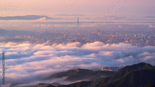 A sea of ​​mist covers the center of Seoul, South Korea in the early morning at sunrise. At the viewpoint on the top of Bukhansan Mountain.Time lapse 4k