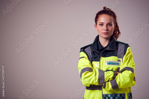 Photos Studio Portrait Of Serious Young Female Paramedic Against Plain Background