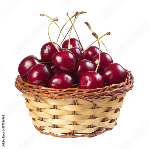Cherry in a wicker basket isolated on white