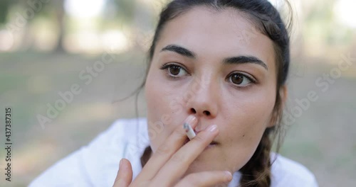 portrait of a woman smoking cigarettes photo