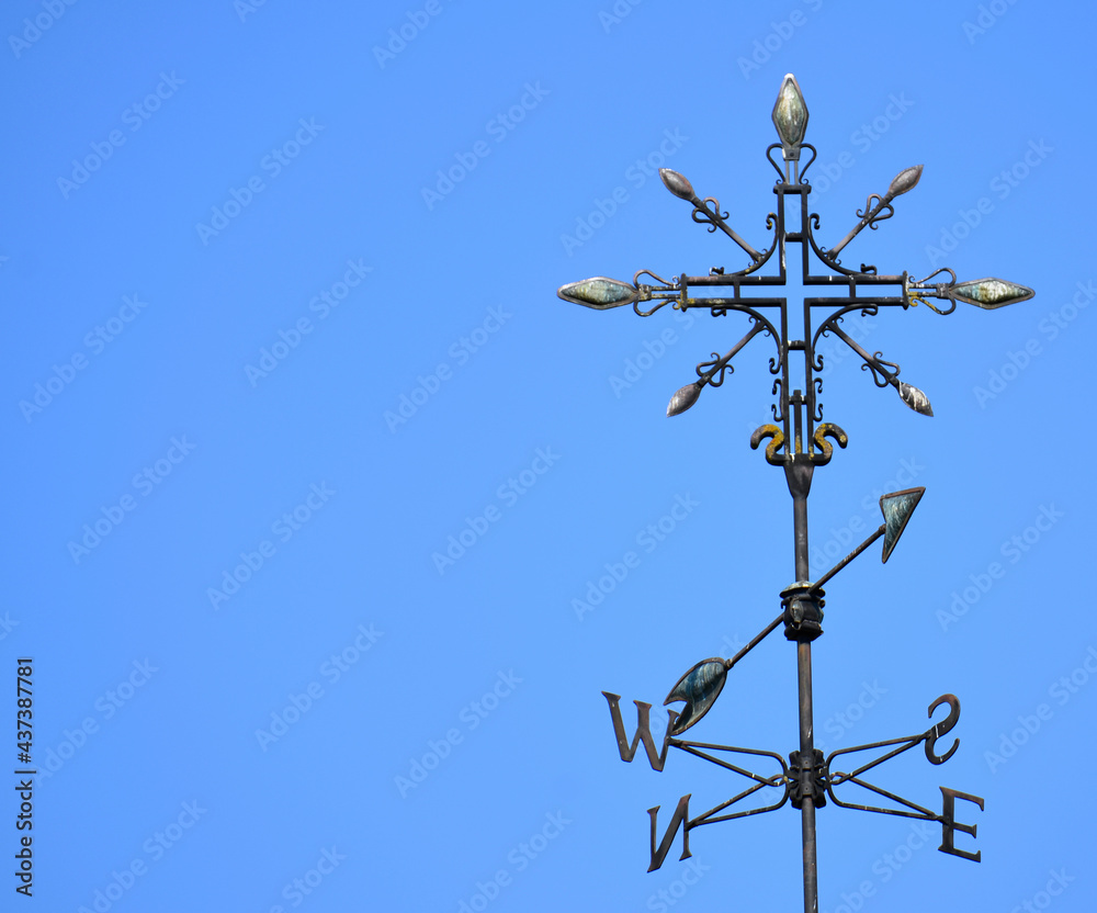 Metal compass in sunny blue sky Metal compass in sunny blue sky