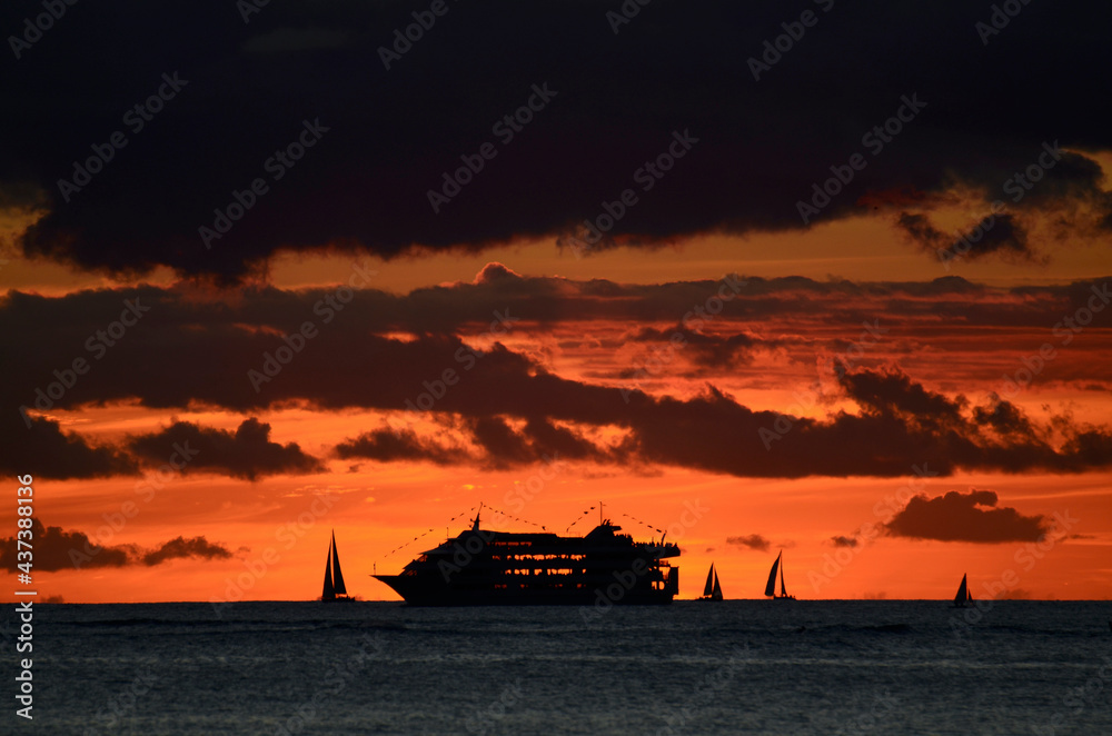 Ship and boats silhouettes at Waikiki Beach sunset Hawaii