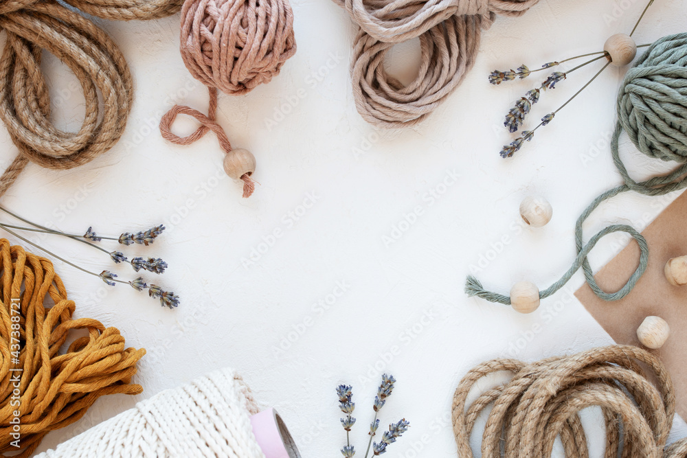 Beautiful layout of materials for macrame: cotton cords, jute twine, wooden beads. Flat lay. - obrazy, fototapety, plakaty 