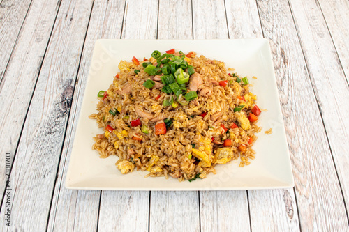 Latin recipe of arroz chaufa with fresh vegetables, scrambled eggs and fried chicken photo